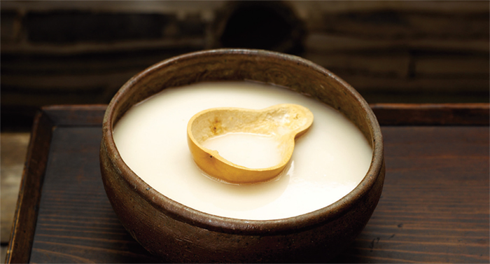 Makgeolli is a traditional Korean rice wine, made by fermenting steamed rice, barley, or wheat mixed with nuruk, a traditional Korean fermentation starter.